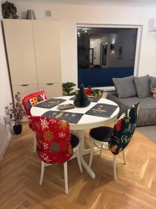 a living room with a table and chairs and a couch at Domek Marzenie in Radawa
