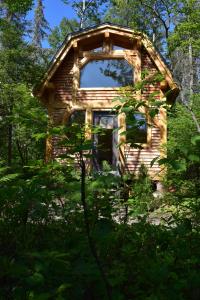 una cabaña de madera en medio de un bosque en Bois Rond Expérience, en Saguenay