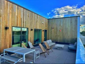 a patio with a table and chairs on a building at Forestline Suite in Des Moines