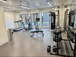 a gym with several treadmills and exercise bikes at Forestline Suite in Des Moines