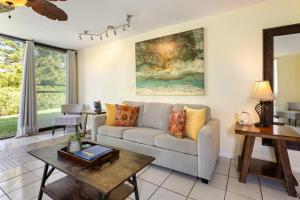 a living room with a couch and a table at The Beach Nook at Turtle Bay in Kahuku