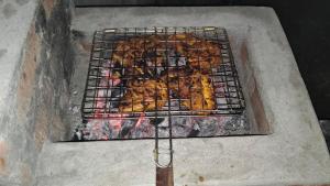 a grill full of fried food on top at Airin's Villa in Agali