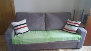 a couch with two pillows on top of it at Apartamento Bloque 3 in Tarifa