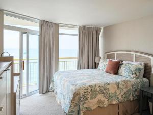 a bedroom with a bed with a view of the ocean at Beautiful Beachfront 2BR2Bath & 2 Balconies in North Myrtle Beach +16 photos