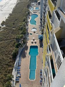 a view of the beach from the balcony of a resort at Beautiful Beachfront 2BR2Bath & 2 Balconies in North Myrtle Beach