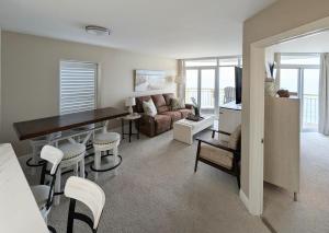 a living room with a couch and a table and chairs at Beautiful Beachfront 2BR2Bath & 2 Balconies in North Myrtle Beach