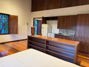 a kitchen with wooden cabinets and a counter top at Atelier-homeoffice in Pirenópolis +18 photos