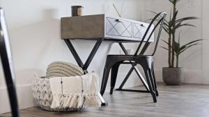 a black chair next to a table with a laptop at Inn at Seacrest Beach 408 in Rosemary Beach