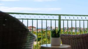 a vase sitting on a table on a balcony at Inn at Seacrest Beach 408 in Rosemary Beach