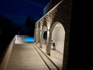 a building with a bridge with a swimming pool at night at Villa Anni in Kremena