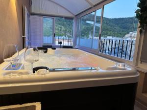 a bath tub with two wine glasses in it at Avi Rooms in Chiaramonte Gulfi +49 photos