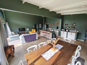 a living room with a wooden table and chairs at Beautiful Breakaway in Champagne Valley