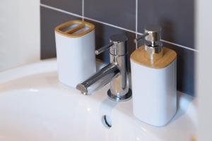 two rolls of toilet paper sitting on a bathroom sink at Perfect 3 Bedroom Banbury Accommodation for Contractors! in Banbury