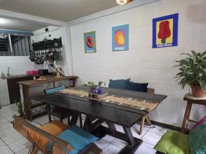 a dining room with a table and chairs at Pool House Hostel in Santa Ana