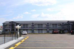 a large building with cars parked in a parking lot at Travelodge by Wyndham Killeen/Fort Hood in Killeen