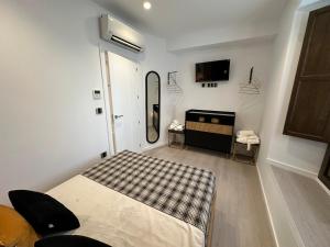 乌贝达Hovalis Sites, The Showroom的有一张床和一台电视的房间