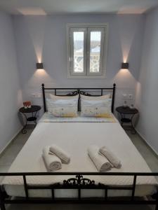 a bedroom with a bed with two towels on it at Aeolus Apartment I in Galaxidhion