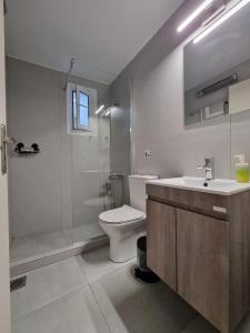 a bathroom with a toilet and a sink and a shower at Aeolus Apartment I in Galaxidhion +33 photos