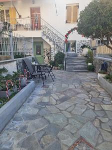 a patio with chairs and a table in front of a building at Aeolus Apartment I in Galaxidhion