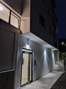 a building with a door with lights on it at Koviljača apartman Demetrios in Banja Koviljača