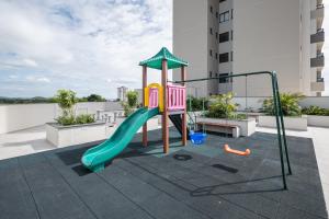 a playground on the roof of a building at Apto Penha a 300M PRAIA 8 min do BETO CARREIRO com PISICNA, sacada com CHURRASQUEIRA privativa, AR CONDICIONADO Wi Fi, PORTARIA 24h,vaga privativa de GARAGEM in Penha
