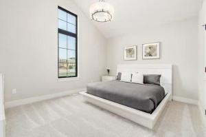 a white bedroom with a bed and a window at Jungle House Luxury Homes - Columbus Downtown Short North - Near Convention Center & Nationwide Arena - Sleeps up to 16 - Free Parking - Over 5,800 Five Stars in Columbus