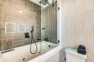 a bathroom with a shower and a bath tub at 2 Mi to Beach Holiday Home in North Cape May in North Cape May +18 photos