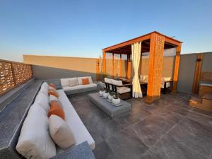 a living room with a couch and a table at VESTA - New Cairo Residence in New cairo