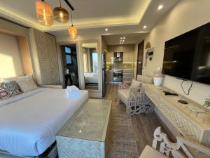 a bedroom with a large bed and a living room at VESTA - New Cairo Residence in New cairo