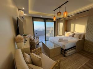 a bedroom with a bed and a living room at VESTA - New Cairo Residence in New cairo