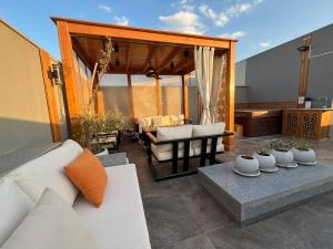 a living room with a couch and a table at VESTA - New Cairo Residence in New cairo +30 photos