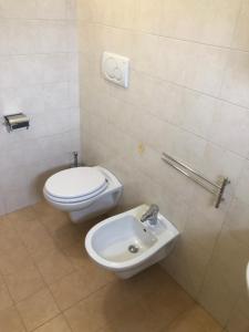 a bathroom with a toilet and a sink at Dimora CentoDue in Bari +10 photos