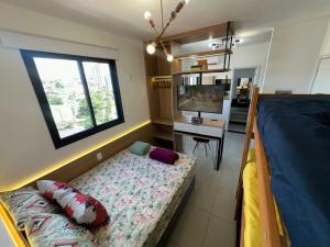 a bedroom with a bed and a desk and a window at TESLA APT2-Pool, Air, gym, 24-hour portaria in São Carlos +48 photos