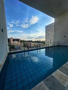 a swimming pool on the roof of a building at TESLA APT2-Pool, Air, gym, 24-hour portaria in São Carlos