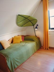 a bedroom with a bed with a lamp on it at Villa Julia 148 in Callantsoog