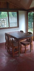 RivasにあるRustic two bedroom house right by the Chirripo riverの部屋の中の木製のテーブルと椅子