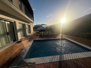 a swimming pool on the deck of a house at Casa Maria Eduarda in Assureira