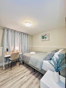 una camera da letto con un letto, una scrivania e un tavolo di Moon's Suite near the New Hospital a Corner Brook