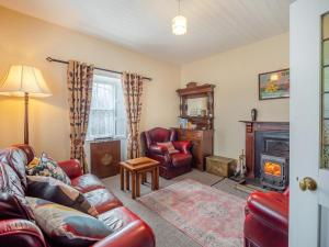 a living room with a couch and a chair and a fireplace at 3 Bed in Bruree oc-i207 in Brú Rí