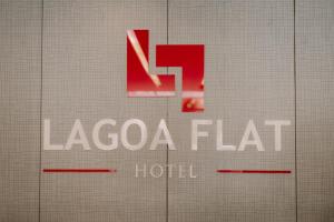 a sign for a laocoa flato hotel at Lagoa Flat Hotel in Lagoa da Prata