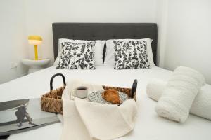 a bedroom with a bed with a tray of food on it at Central 2 bedroom flat in Nicosia