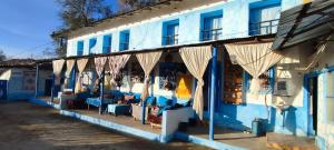 a blue building with tables and chairs in front of it at Dar Nefzi in Ouazzane