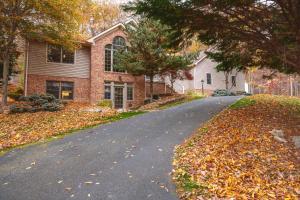 a street in front of a house with leaves on the ground at Green Mountain Song-Massanutten Mountain in McGaheysville