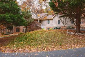 a house with a pile of leaves on the yard at Green Mountain Song-Massanutten Mountain in McGaheysville