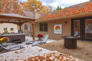 a patio with chairs and a fireplace in front of a house at Green Mountain Song-Massanutten Mountain in McGaheysville