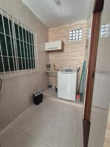 a small bathroom with a sink in a room at Casa Praia Bertioga in Bertioga