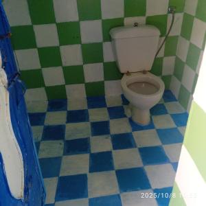 a bathroom with a toilet and a tiled floor at Dar Nefzi in Ouazzane +48 photos
