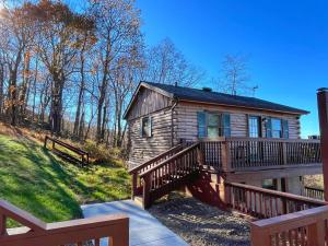 una baita di tronchi con un ampio portico e una terrazza. di Mountain View Log Cabin - Cozy cabin in the Blue Ridge Mountains- New Property! a Big Meadows