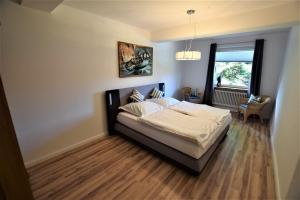 ein Schlafzimmer mit einem Bett und einem Fenster in der Unterkunft Ferienwohnung Alexandra in Hohwacht