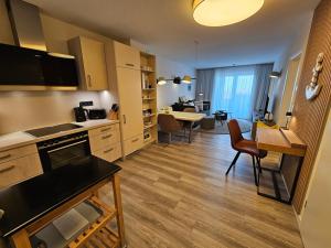 a kitchen and living room with a table and chairs at Meeresblick Appartement 33 H3 WE 33 in Hohwacht